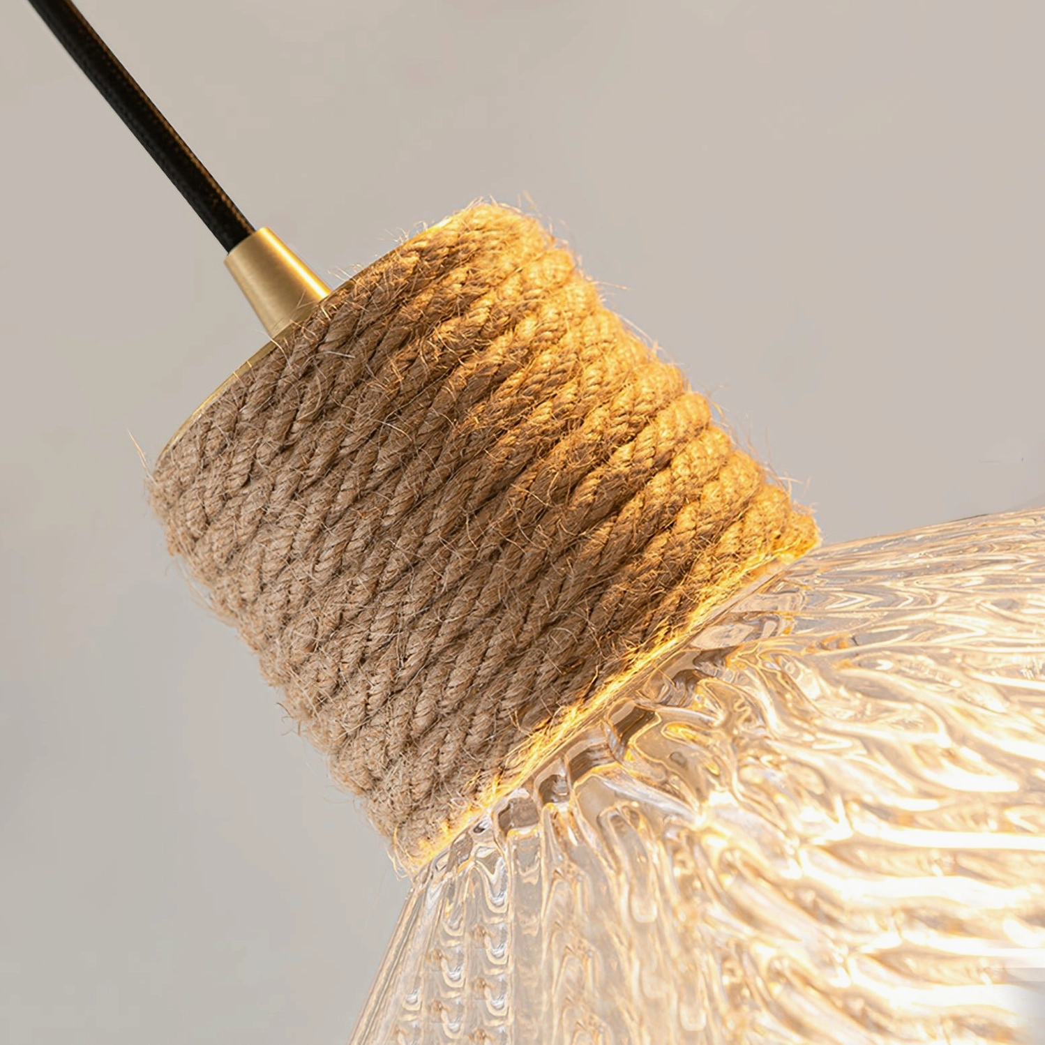 Hemp rope glass pendant lamp illuminated in evening light, warm frosted glass diffuser ambient lighting effect