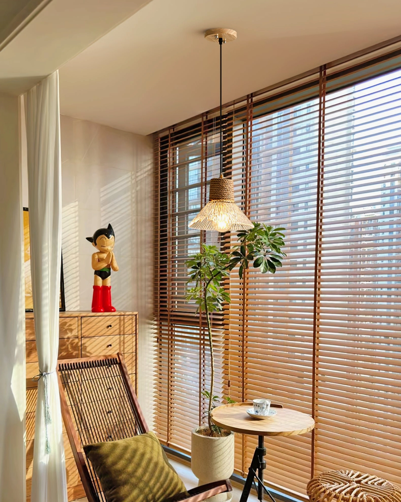 Detail shot of woven hemp rope wrapped around glass shade, artisanal natural fiber pendant lamp texture