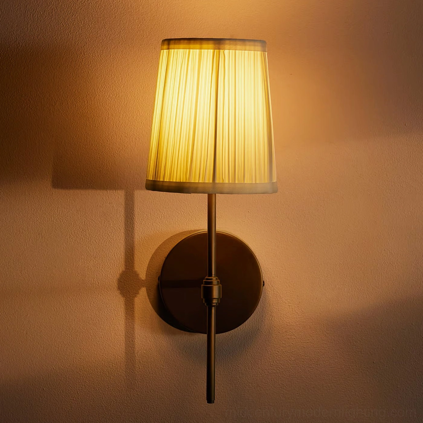 Illuminated Henley wall sconce with warm glowing light through pleated shade creating cozy vintage ambiance