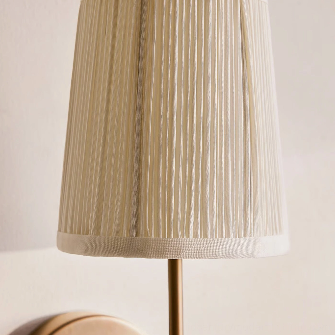 Close-up detail of Henley wall sconce pleated fabric shade showing vertical pleating and white trim edge