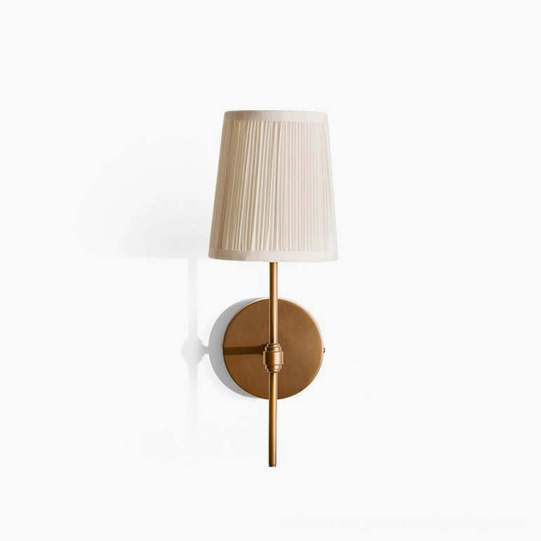 Henley brass wall light with adjustment detail and off-white pleated shade on studio white background