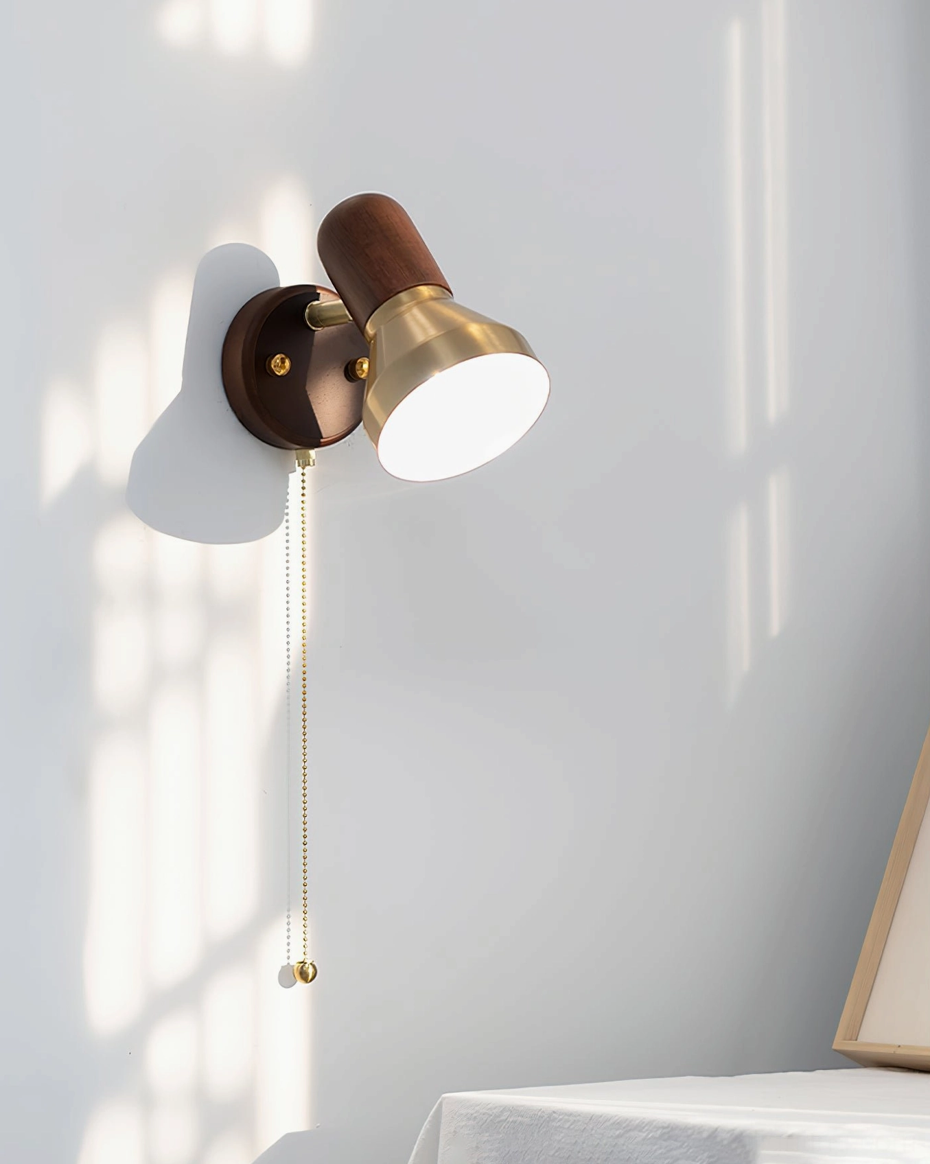 Product showcase of Heron mid-century modern wall sconce with sculptural brass shade