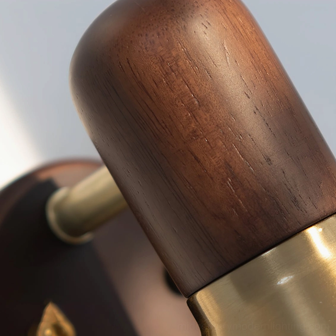 Close-up macro detail of natural walnut wood grain on Heron wall sconce base
