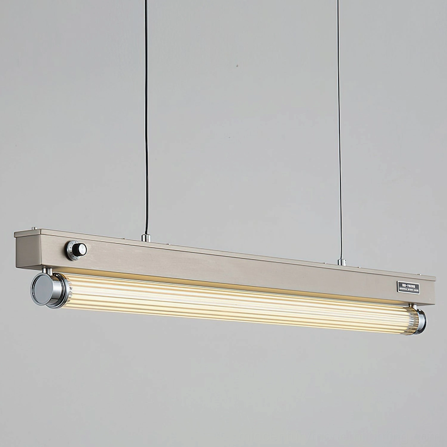 Hiromi pendant light side profile showing dimmer control knob and brushed metal frame with hanging wires