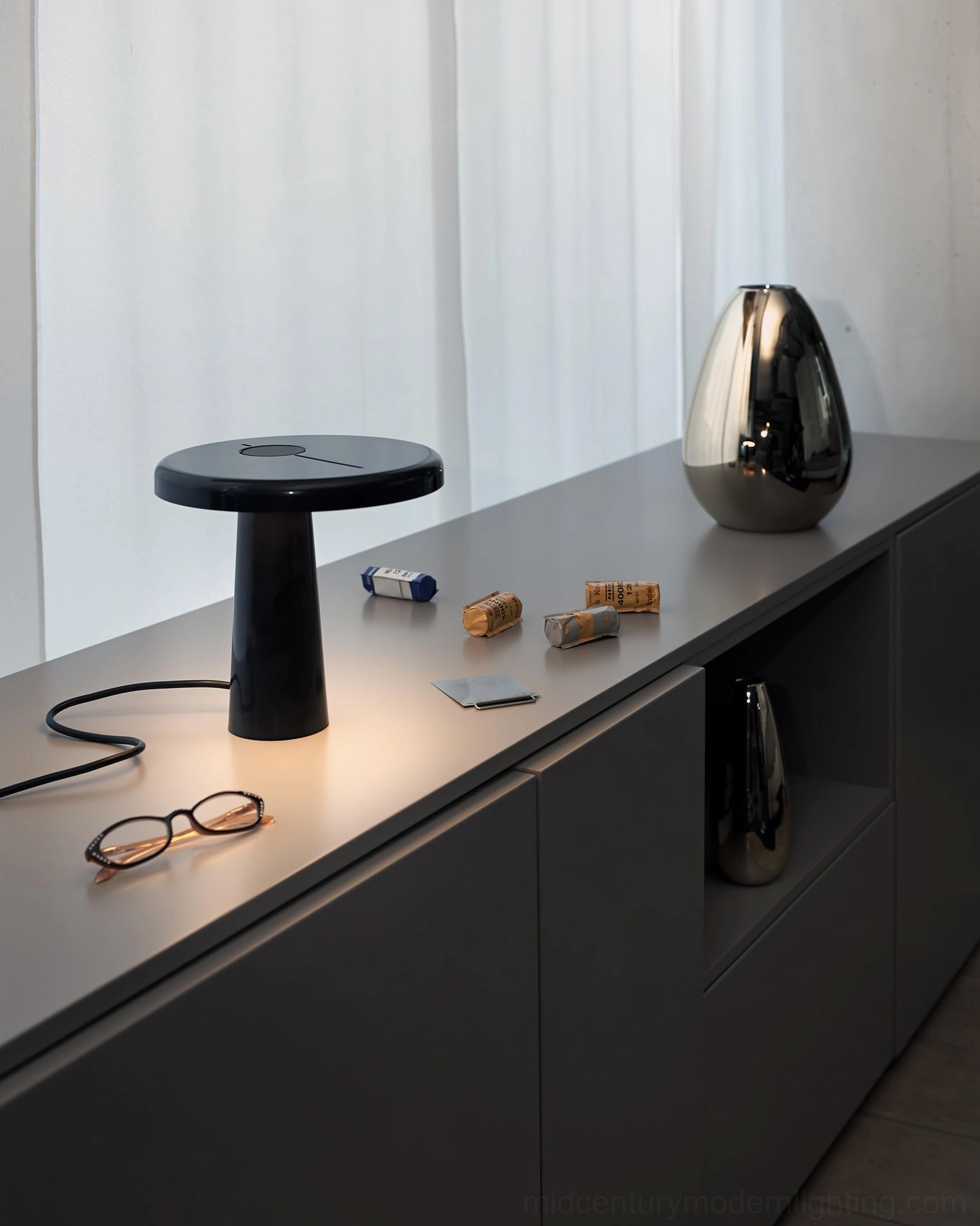 Hoop LED table lamp in industrial modern setting with exposed elements, contemporary workspace