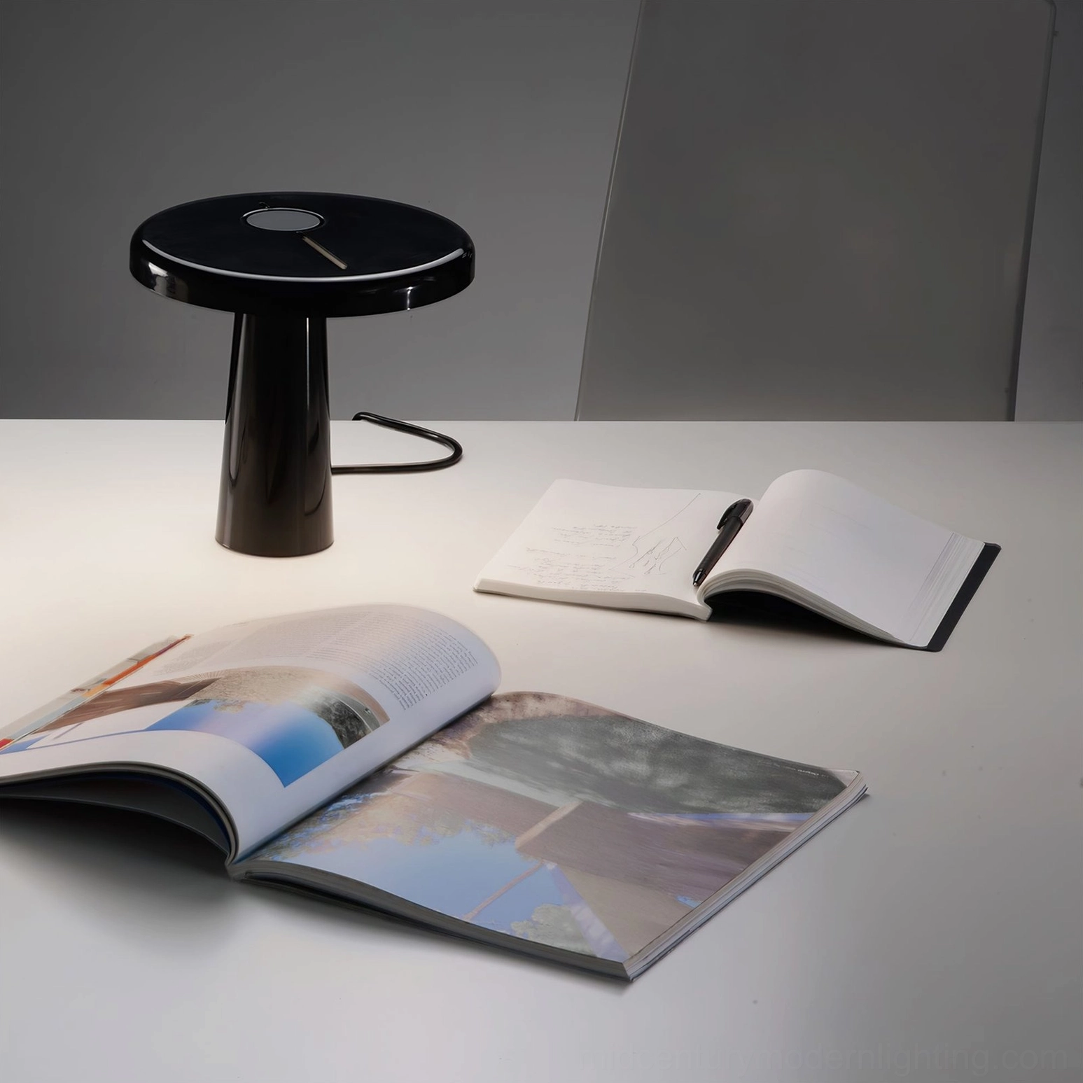 Overhead view of Hoop LED table lamp on creative workspace with magazines, notebook, minimalist modern design