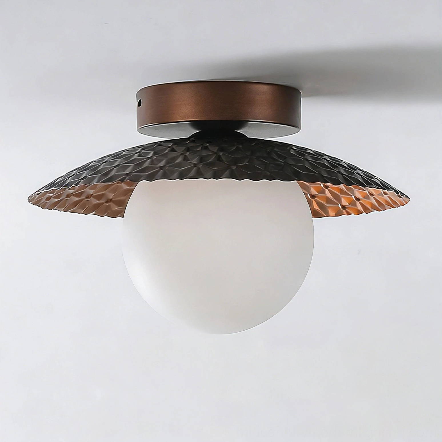 Close-up detail of Hooper flush-mount lamp showing hammered metal texture and copper inner finish of the acrylic diffuser