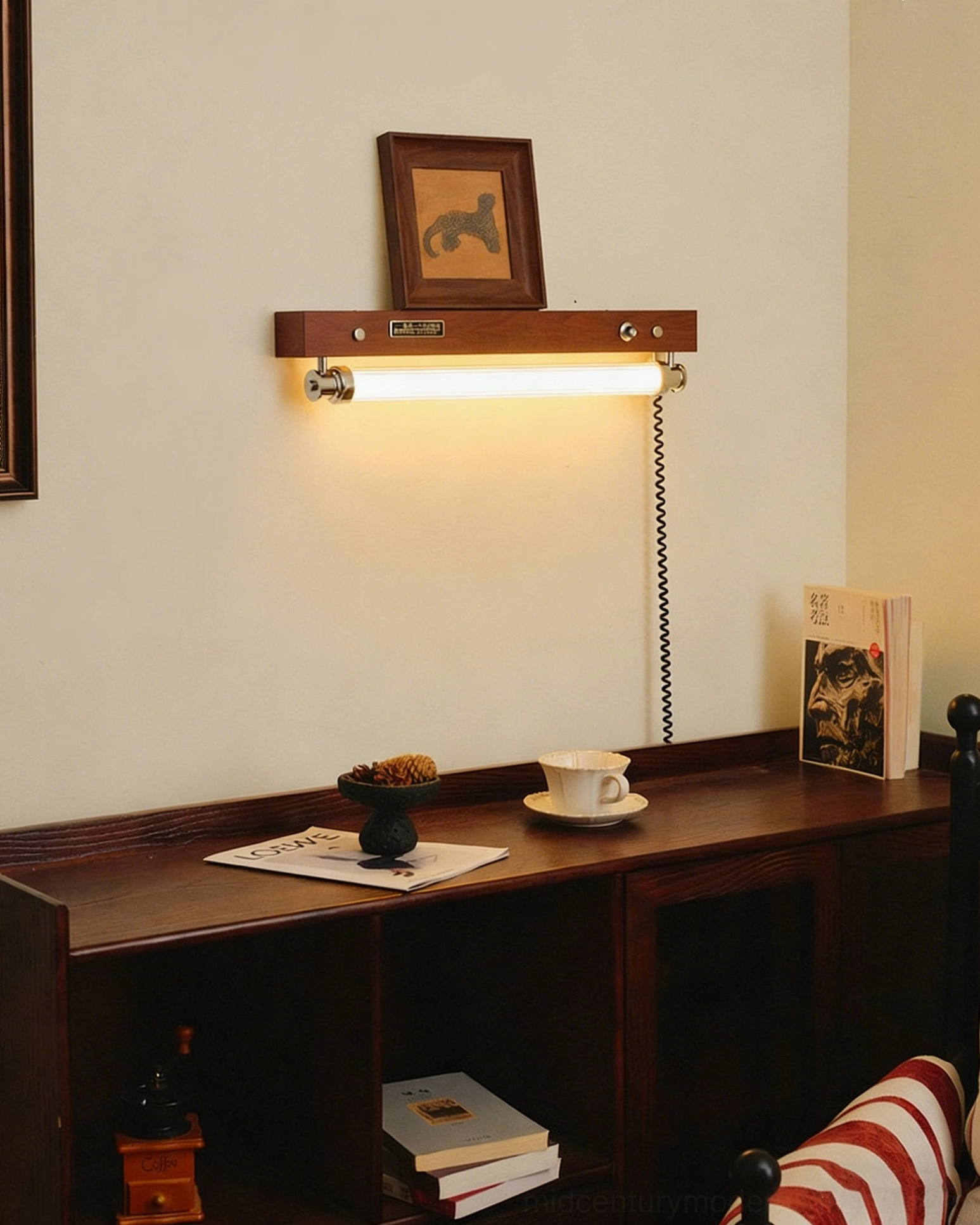 Hopper plug-in wall sconce mounted above wooden console table with desk storage and framed artwork display