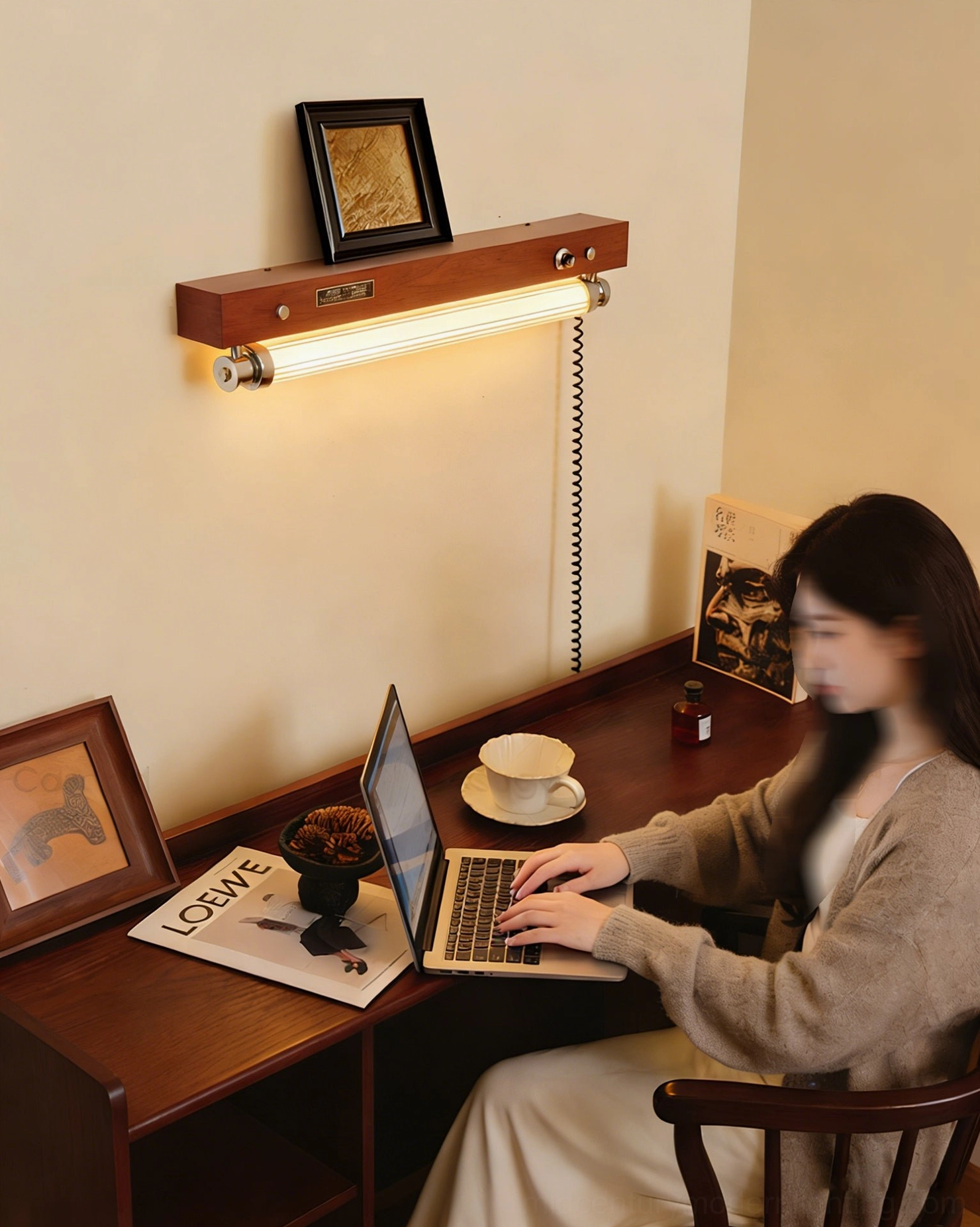 Hopper wall sconce installed in home office providing ambient light over writing desk with vintage decor