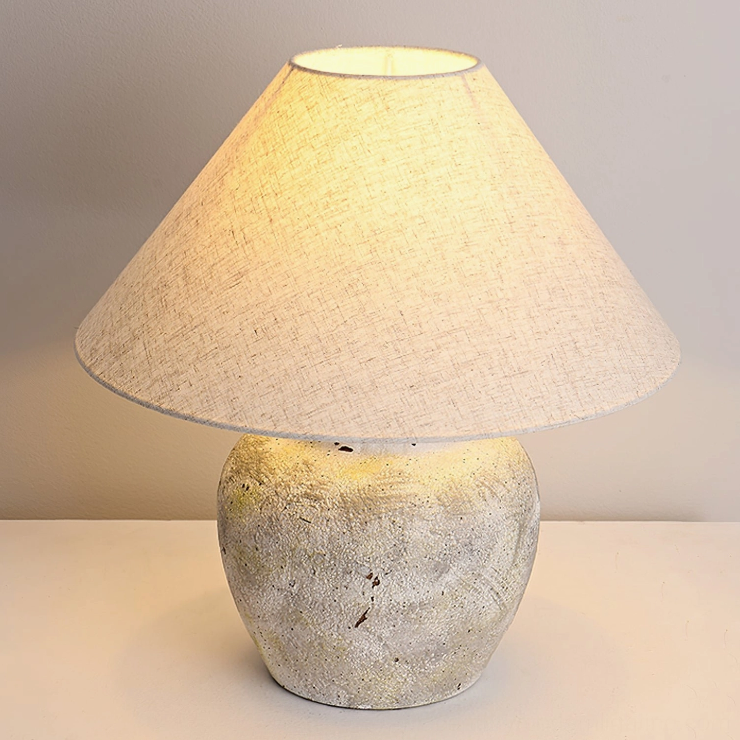 Extreme close-up of Houa ceramic lamp base showing rough porous weathered texture detail