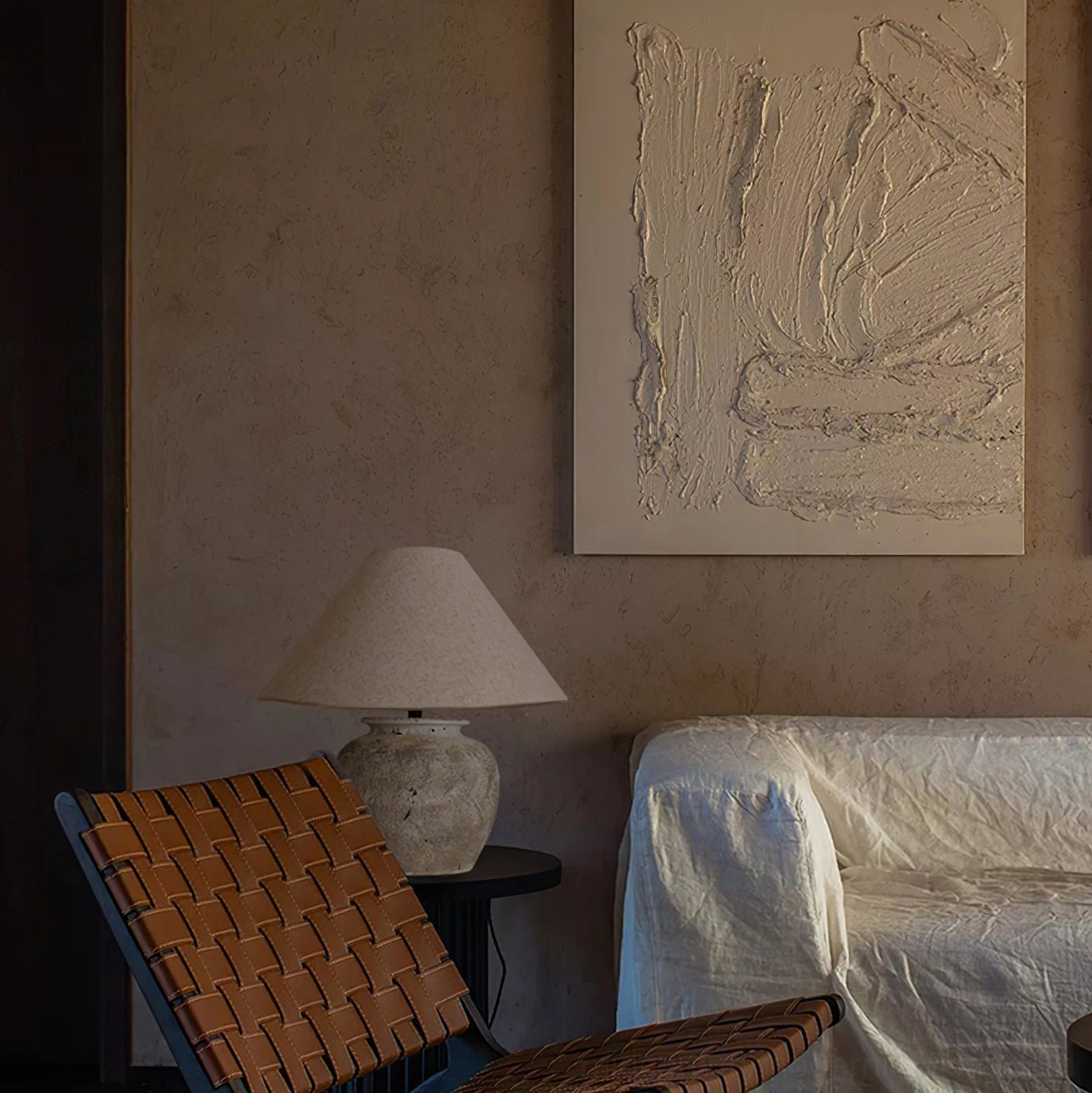 Houa ceramic lamp creating warm ambient lighting in bohemian living room with woven accents