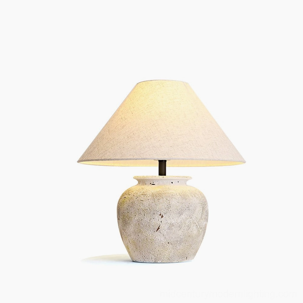 Houa ceramic table lamp with aged sandstone base and natural linen shade - front studio view