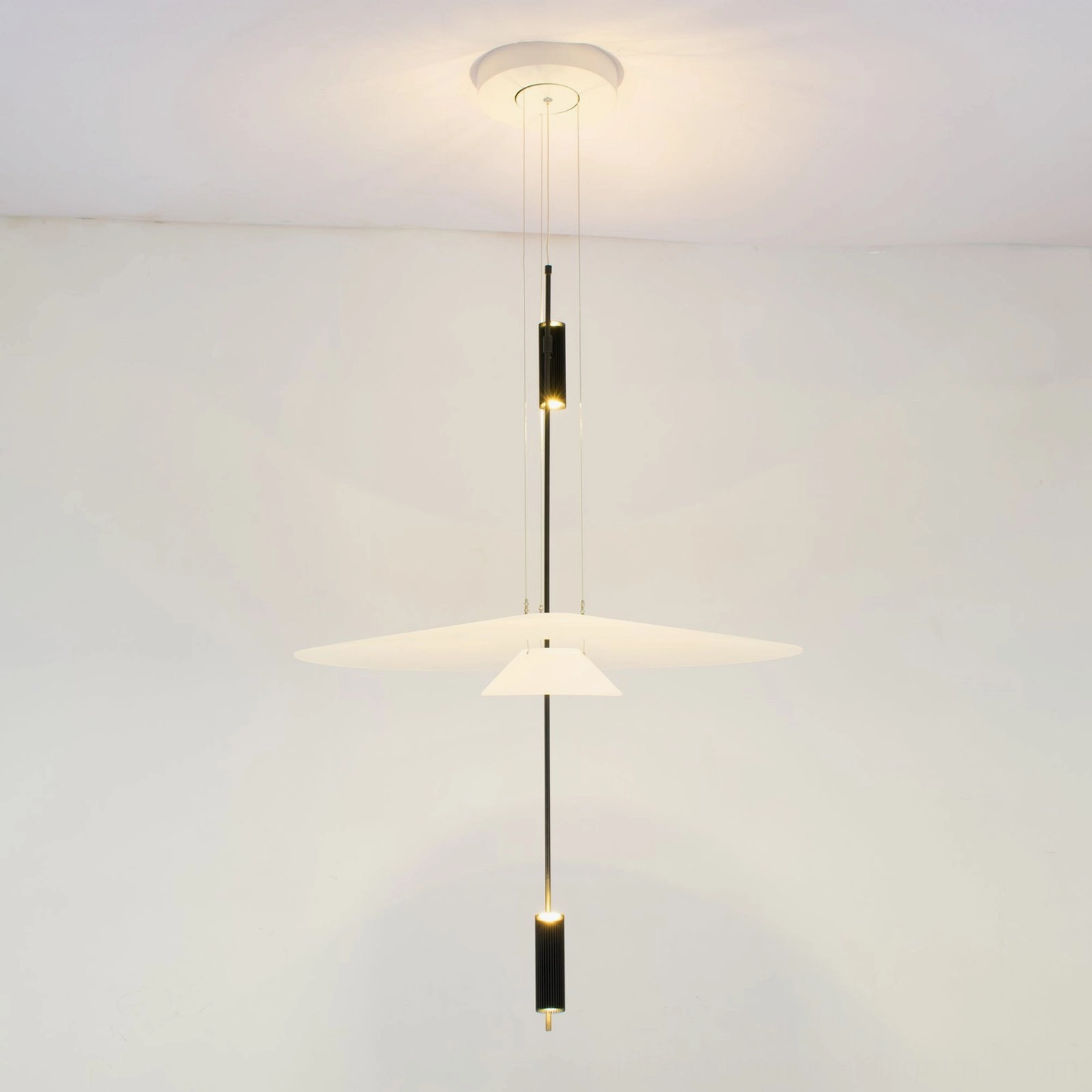 Modern Hover Disc pendant chandelier with brass metal hardware in contemporary interior space