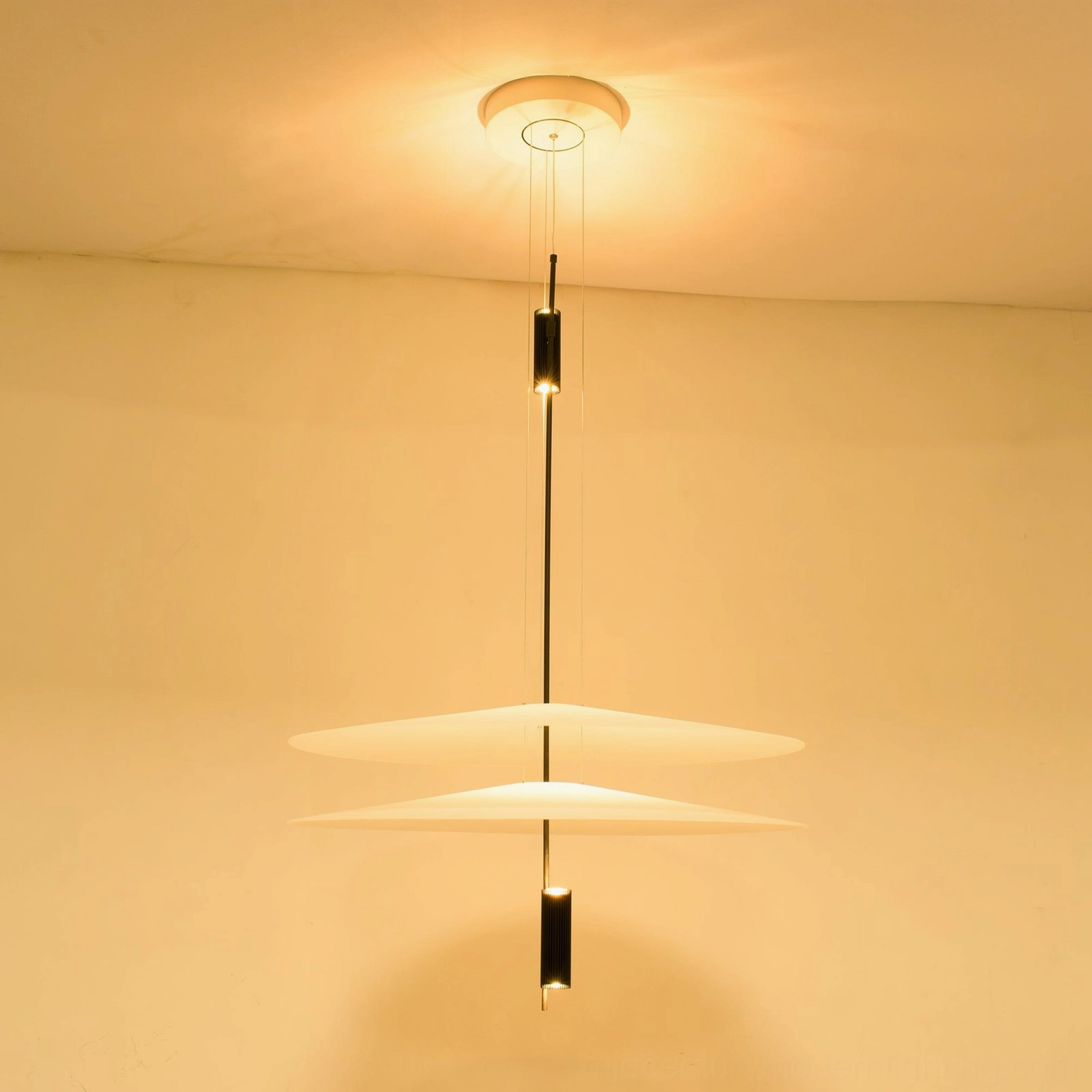 Detailed view of Hover Disc pendant showing precision counterweight balance and cable suspension