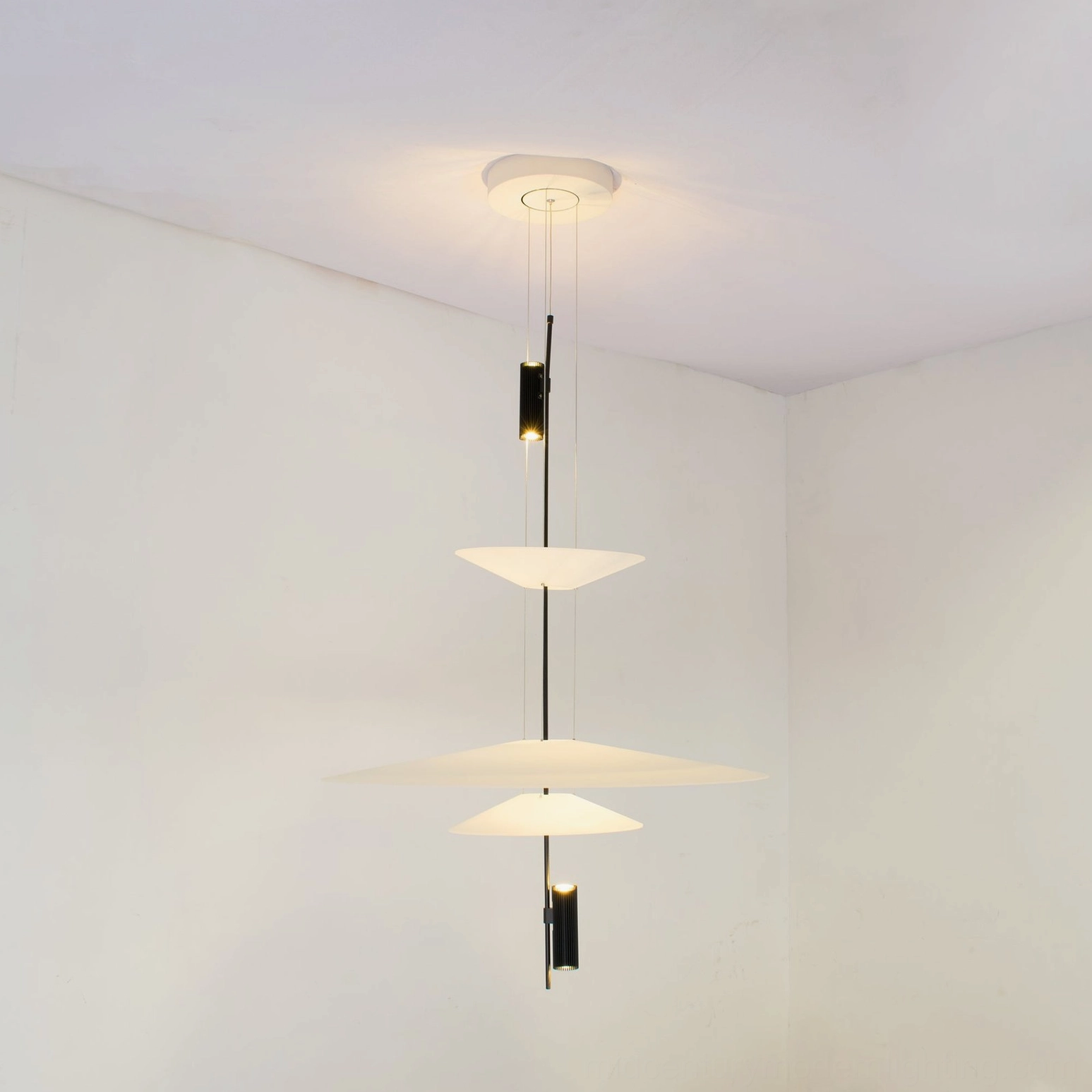 Hover Disc pendant chandelier styled in dining room setting with warm interior design elements