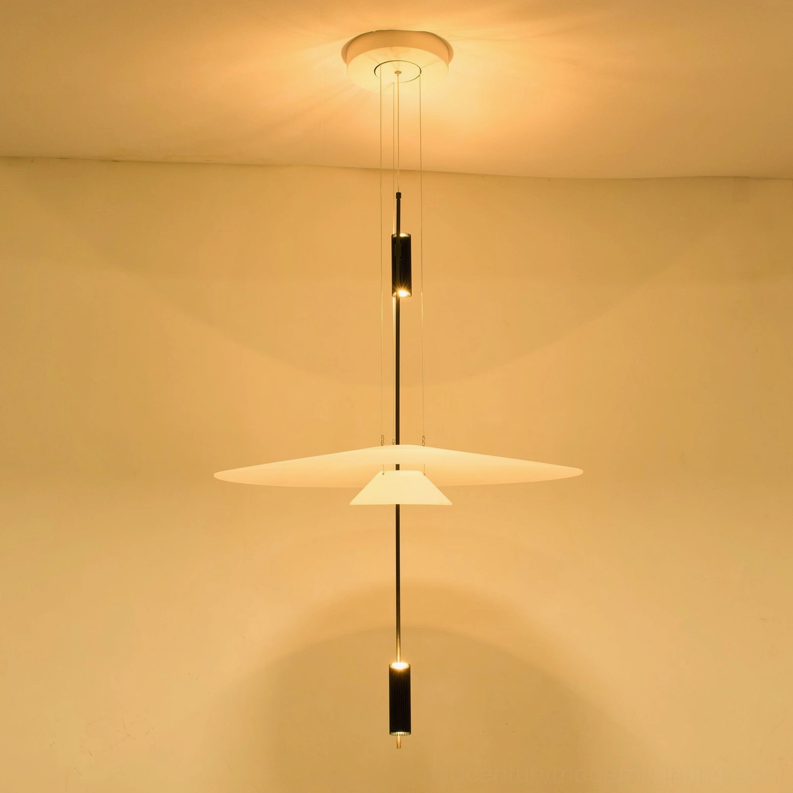 Oversized Hover Disc chandelier pendant with large white acrylic shade and warm accent lighting in modern space