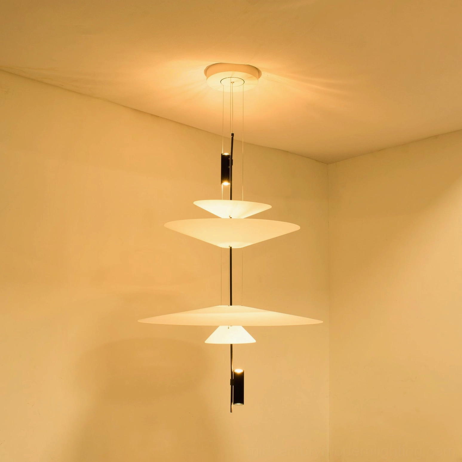 Hover Disc pendant chandelier showing light distribution and glow pattern in darkened room