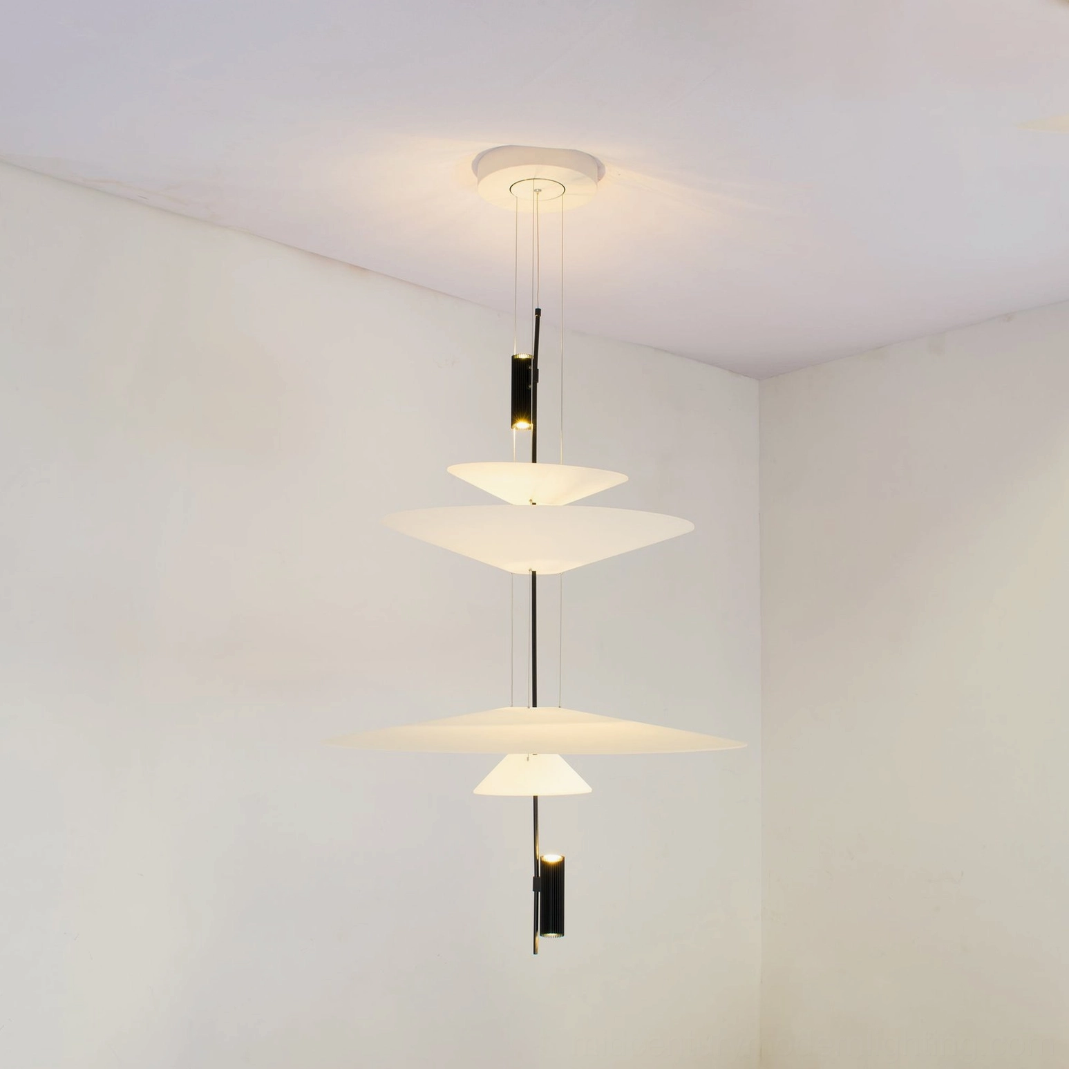 Hover Disc chandelier pendant with sculptural floating disc design in minimalist interior space