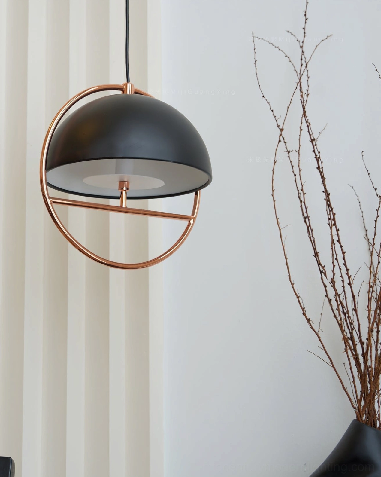 Sleek black matte dome pendant lamp with rose gold metal ring close-up view with minimal interior styling