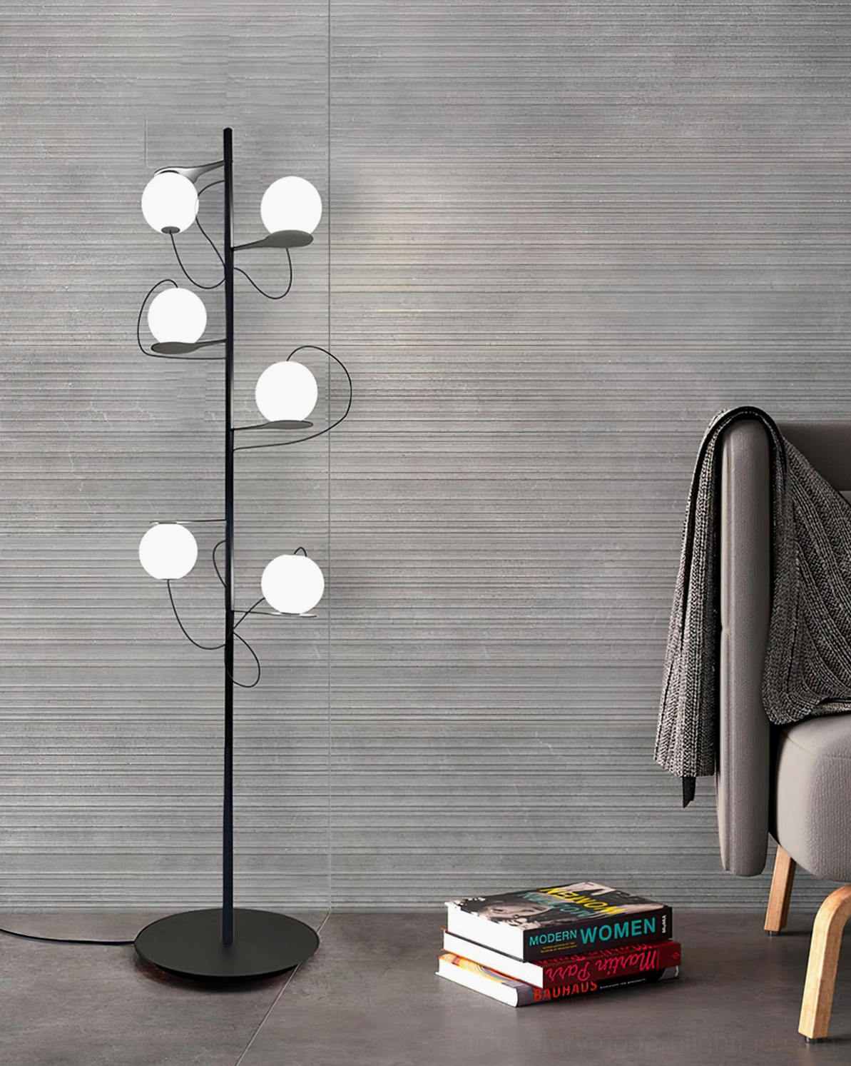 Nordic minimalist floor lamp with evenly spaced frosted glass globes and matte black metal frame against textured grey accent wall