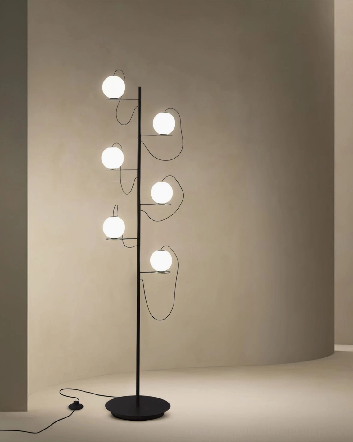 Simple modern Hubble Bubble floor lamp with curved asymmetrical arms and round black base in minimalist interior corner design