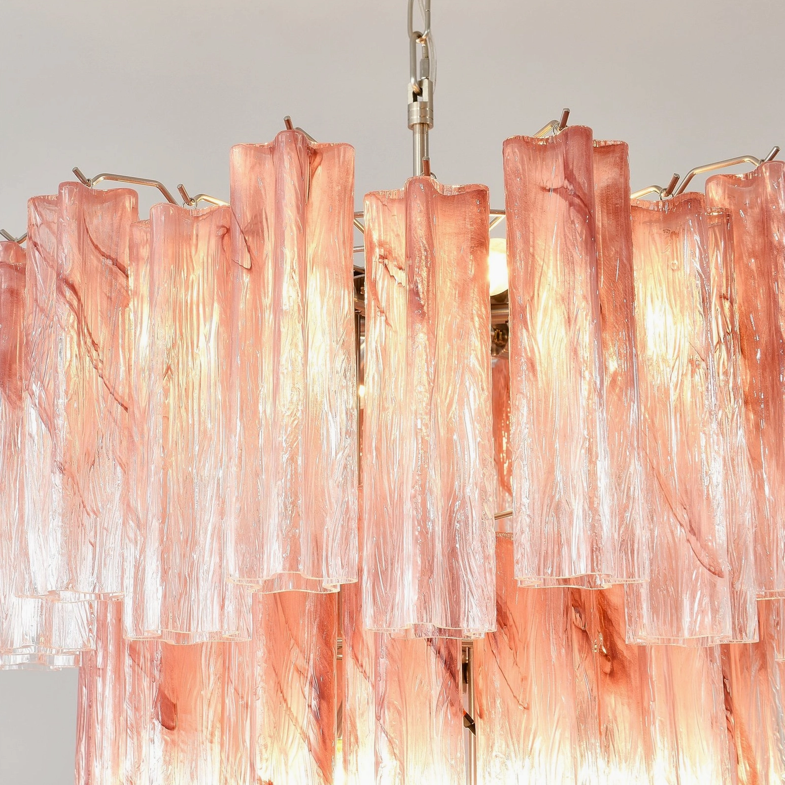 Pink Murano tube chandelier illuminated showing light reflection and color saturation of handcrafted glass