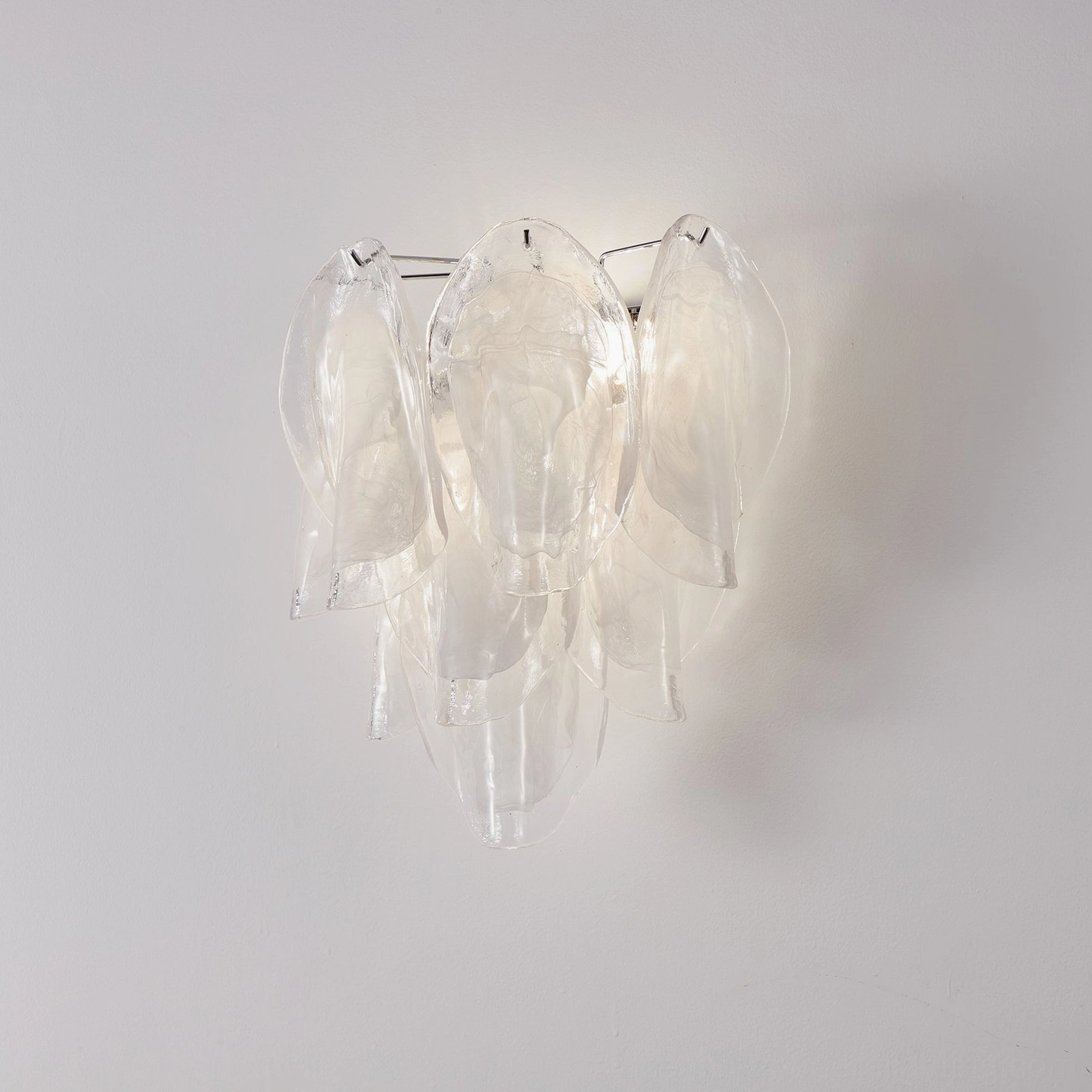 Ina glass wall sconce showing symmetrical petal arrangement and chrome mounting hardware