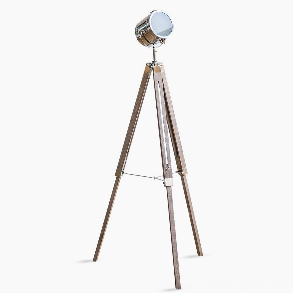Industrial tripod floor lamp with adjustable spotlight head, polished chrome metal and camphor pine wood construction, front full-body view on white background