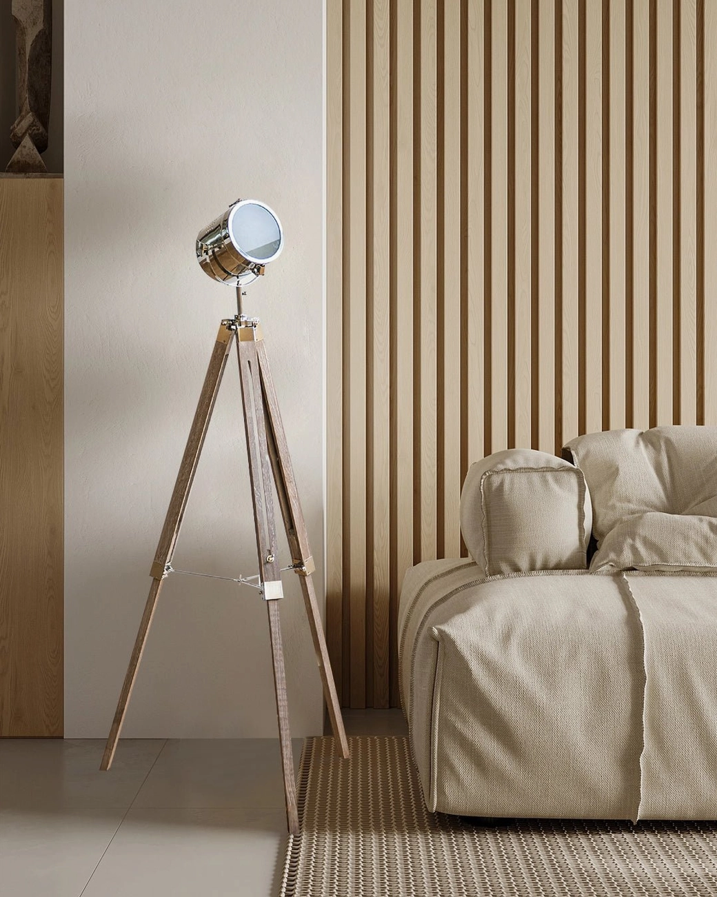 Industrial tripod floor lamp with natural wood stand and polished metal shade in minimalist living room with fabric sofa and modern décor