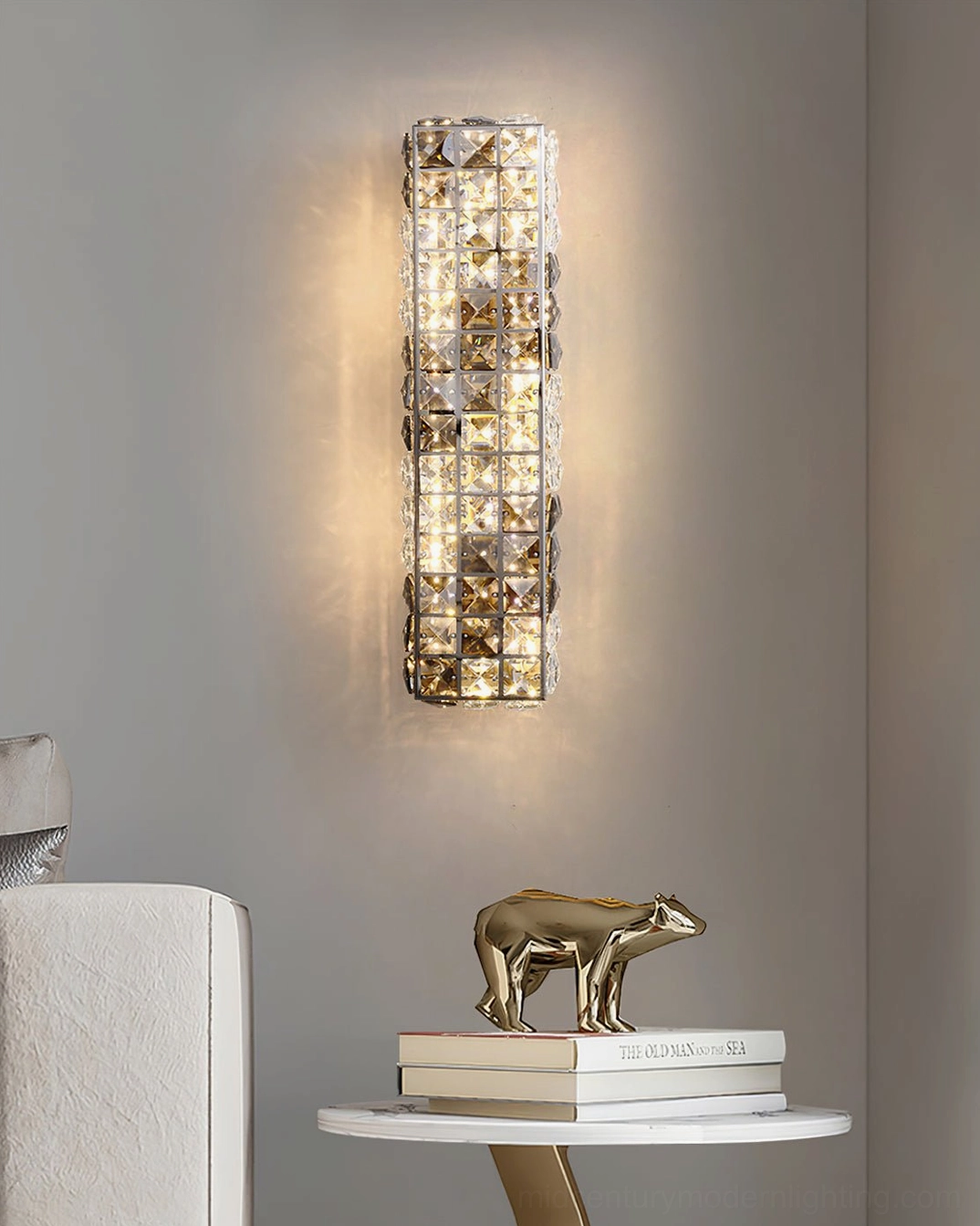 Crystal wall lamp with integrated LED creating ambient glow in contemporary interior with decorative accessories