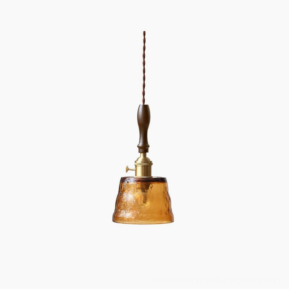 Jace amber glass pendant lamp with walnut wood handle and brass hardware, front studio view
