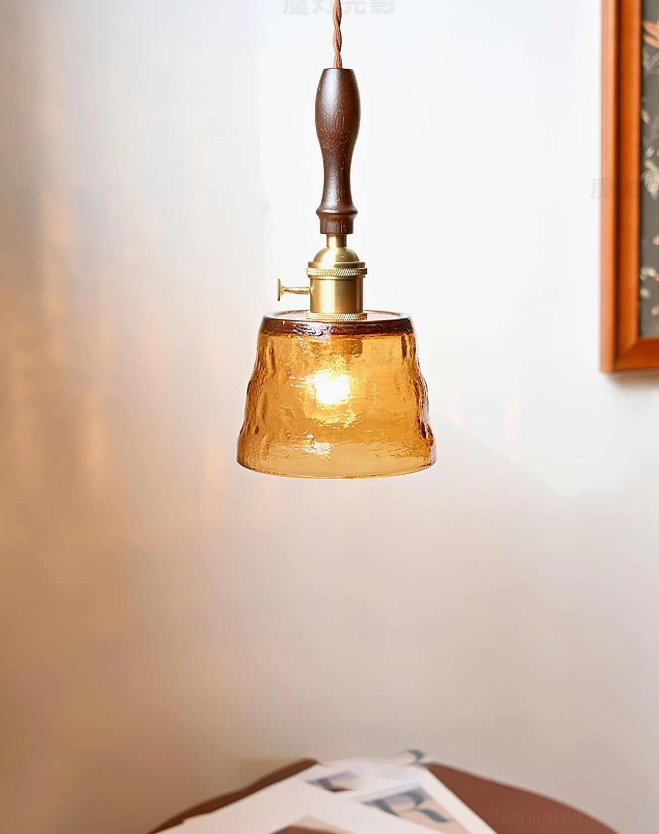 Jace amber glass pendant shade with brass switch detail, side view in home setting