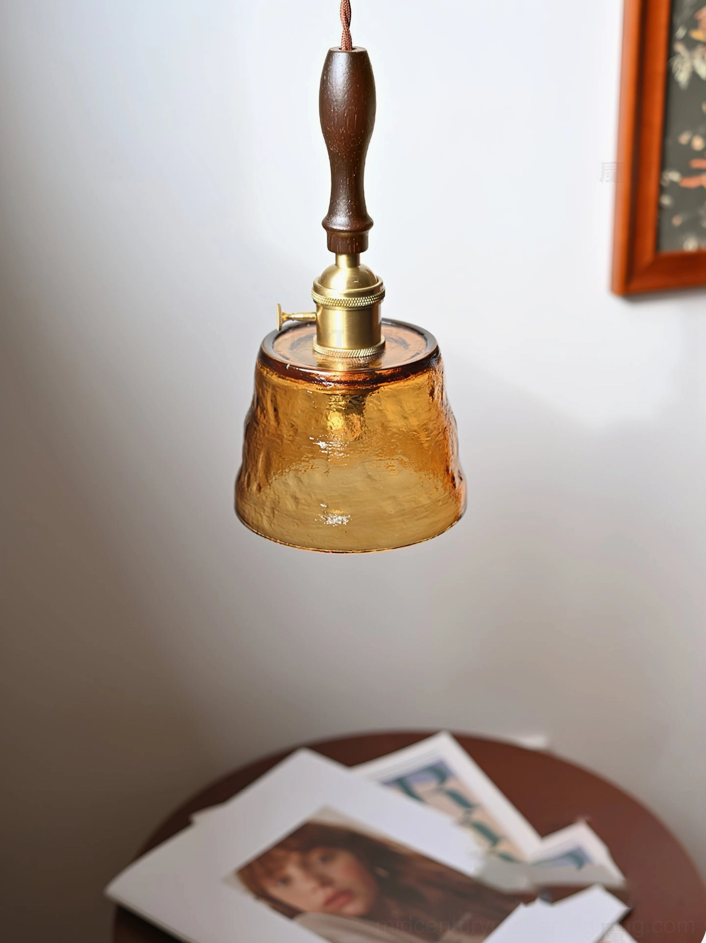 Jace pendant lamp bottom-up view showing solid brass base and walnut wood handle construction