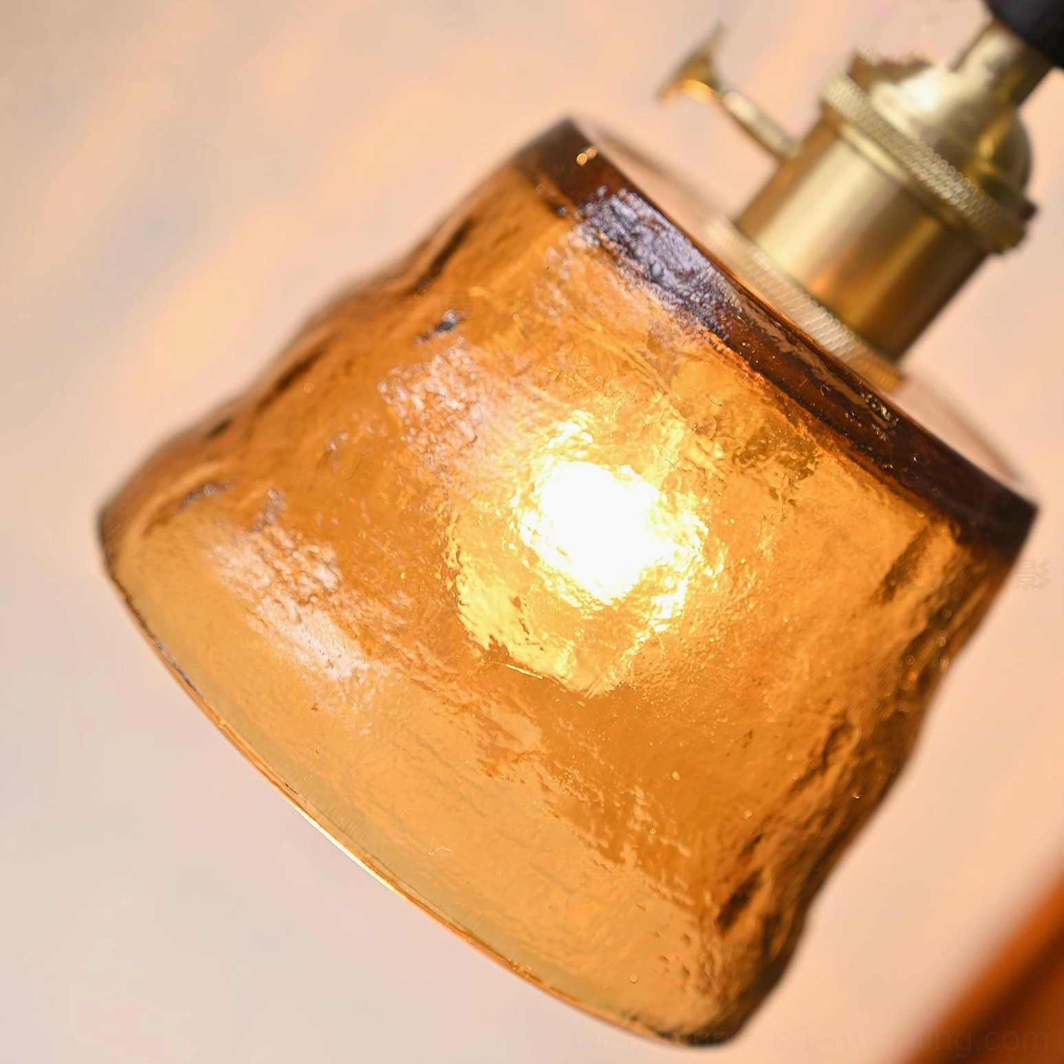 Jace pendant handle close-up displaying polished dark wood and brass lamp base connection