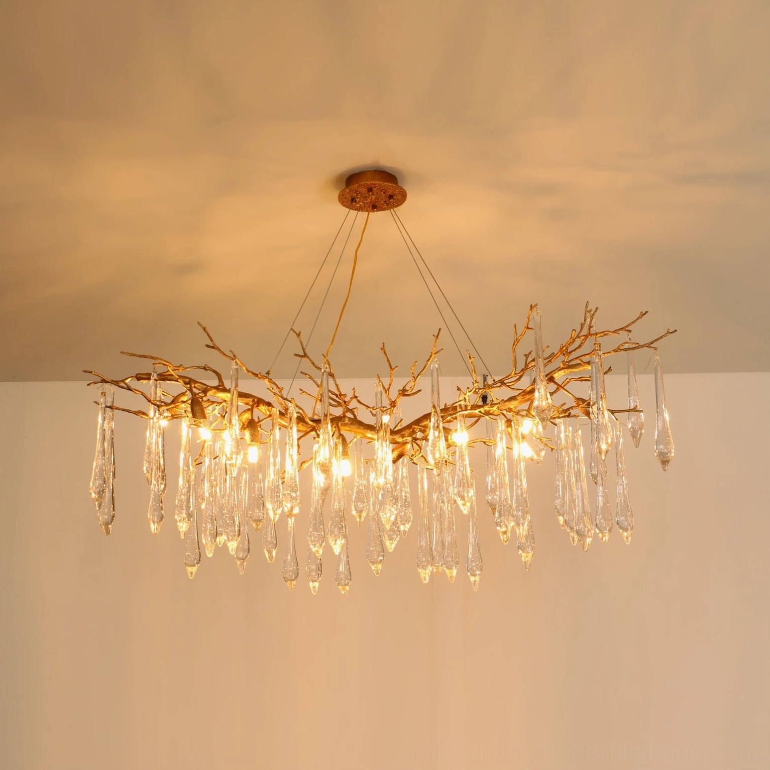 Janae symmetrical brass chandelier centered overhead view, unlit clear crystals with round brass ceiling canopy mount