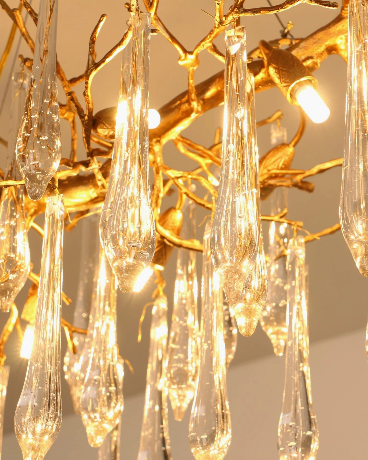 Janae branch-style chandelier extreme close-up revealing individual crystal pendants and polished brass frame construction