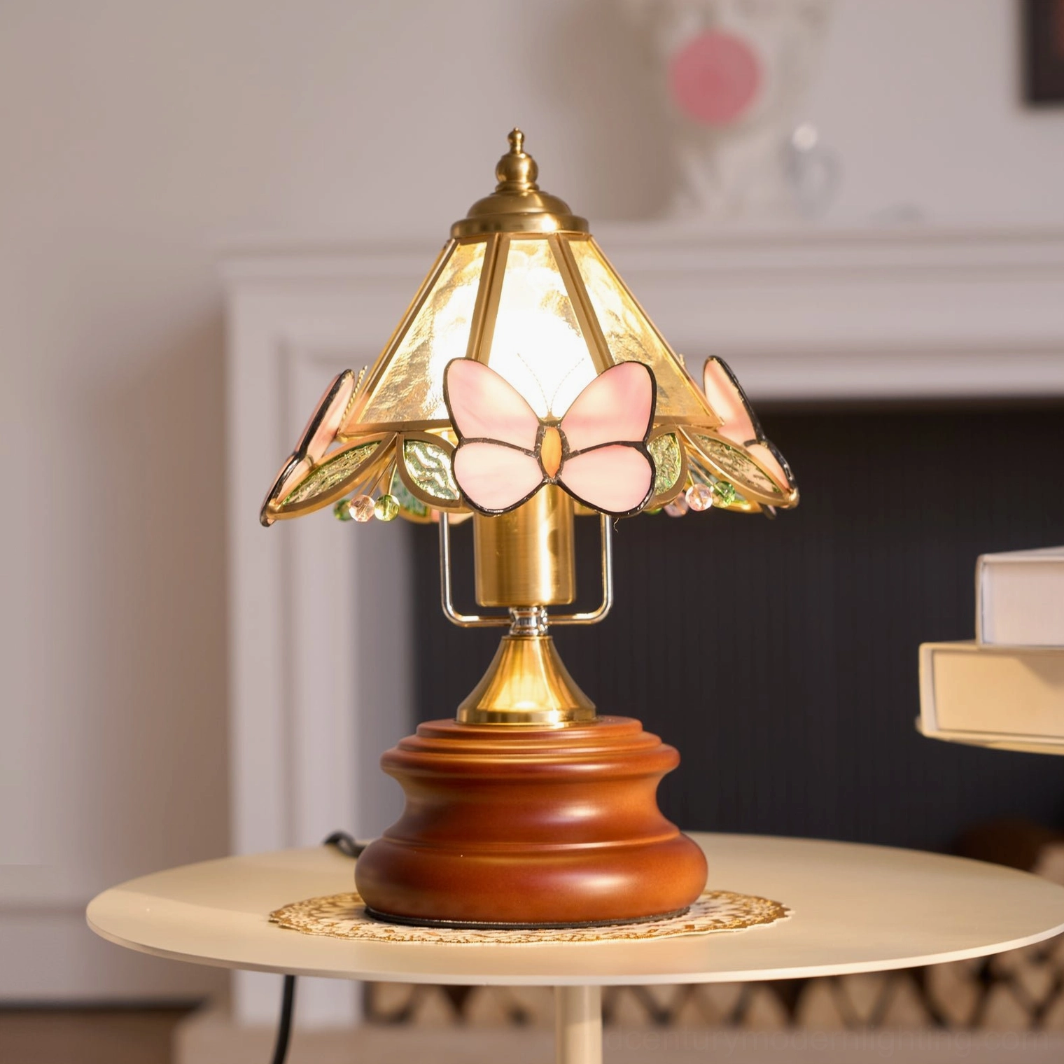 Butterfly table lamp with warm glowing pink shade and butterfly details positioned in living room near fireplace, ambient lighting