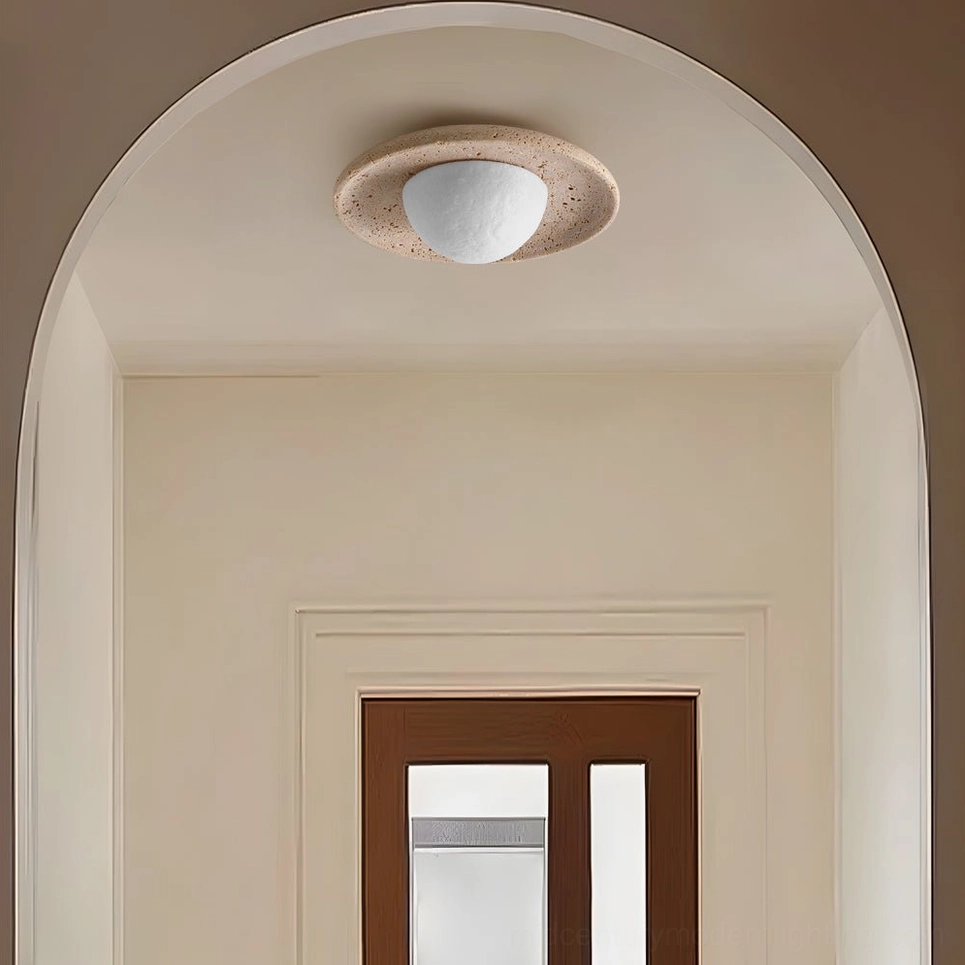 Jenny travertine ceiling light installed in modern arched entryway with warm minimalist interior design aesthetic