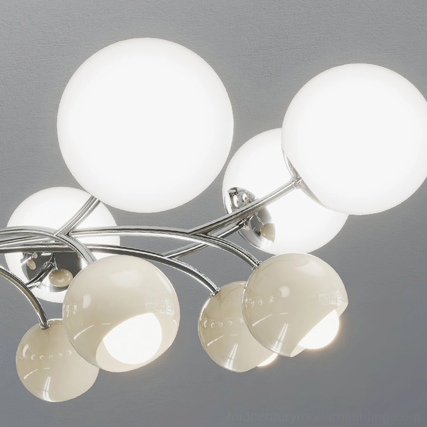 Low-angle close-up of Jervon chandelier curved chrome arms and oversized frosted glass lamp shades demonstrating atomic-age design elements