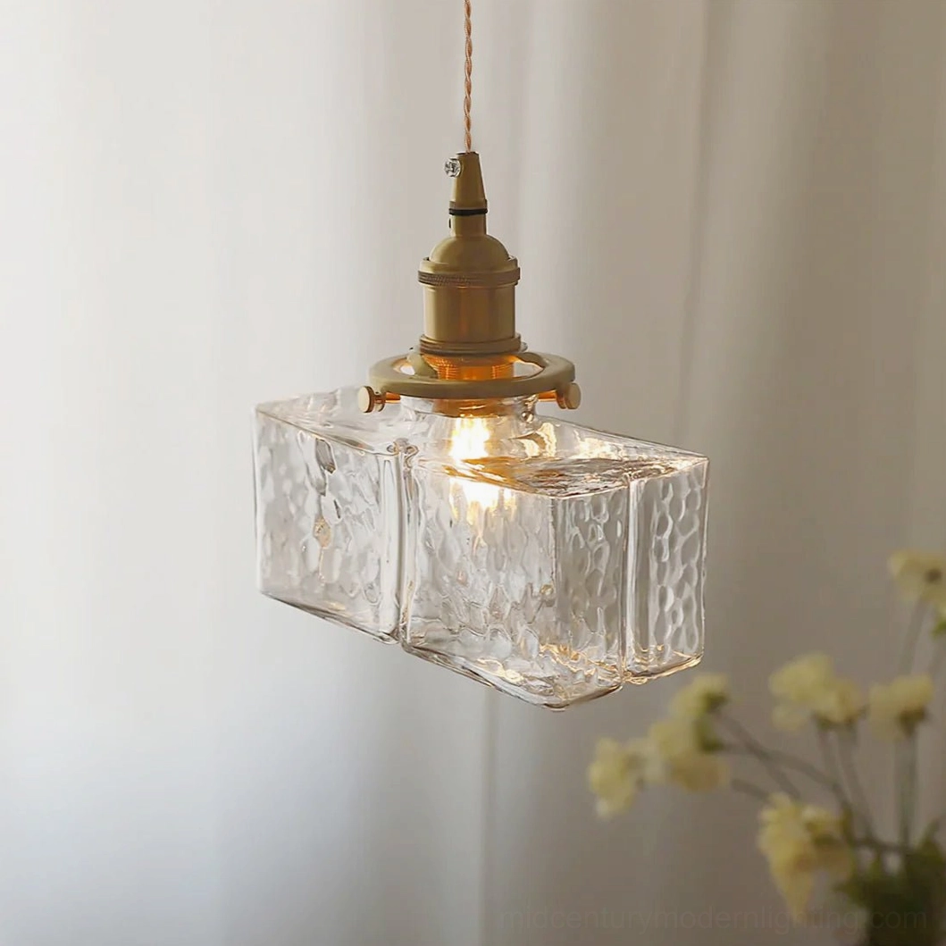 Jewel brass pendant light fixture showing brass frame construction and hammered glass dome shade with warm golden tones