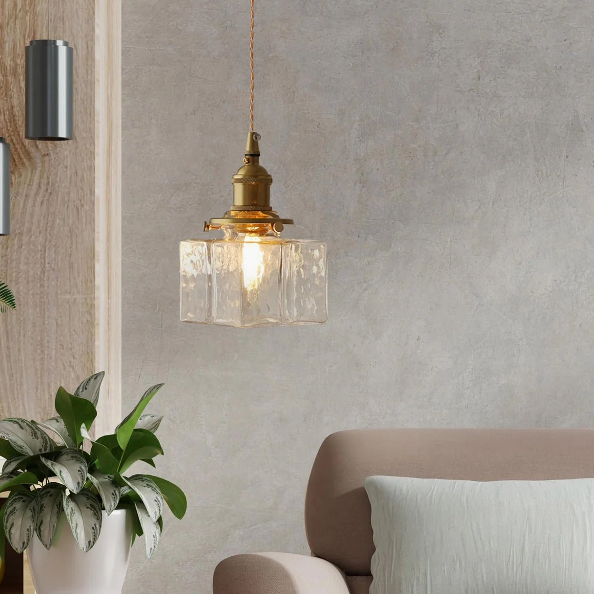 Detail photograph of jewel brass pendant light hammered glass shade showing texture and light refraction properties