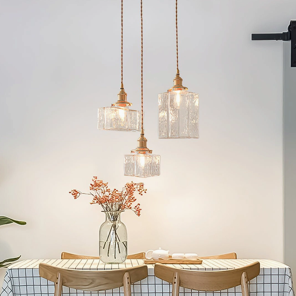 Jewel brass pendant light close-up showing clear hammered glass shade and brass screw base compatibility with bulbs