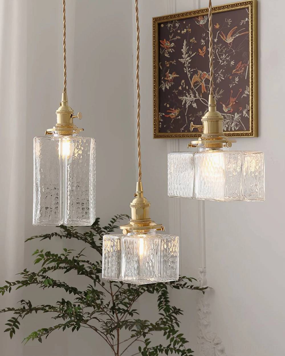 Jewel brass pendant light in entryway space showing Model A compact size and elegant brass hardware against neutral wall