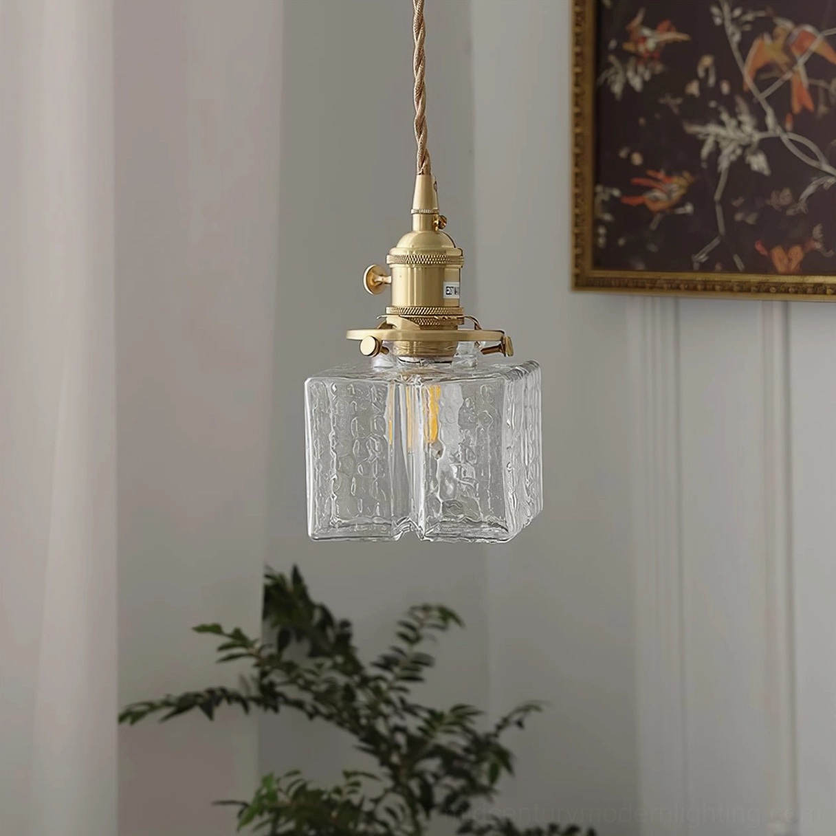 Three jewel brass pendant lights clustered installation showing staggered arrangement and combined light output effect