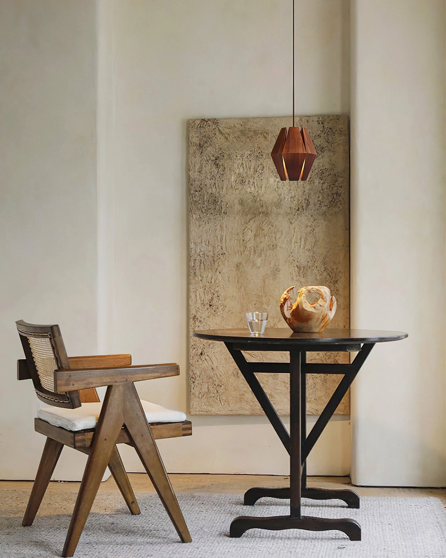 Single Kaden geometric wood pendant light in minimalist dining corner with wooden side chair