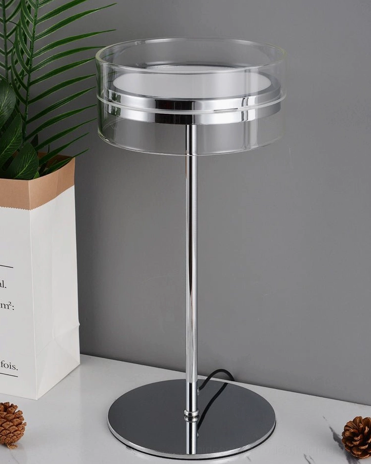 Minimalist chrome stem lamp with clear acrylic shade, side three-quarter view of modern design