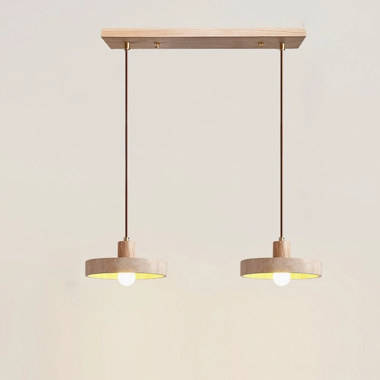 Two Kairi travertine pendants in natural wood finish creating warm ambient lighting in kitchen