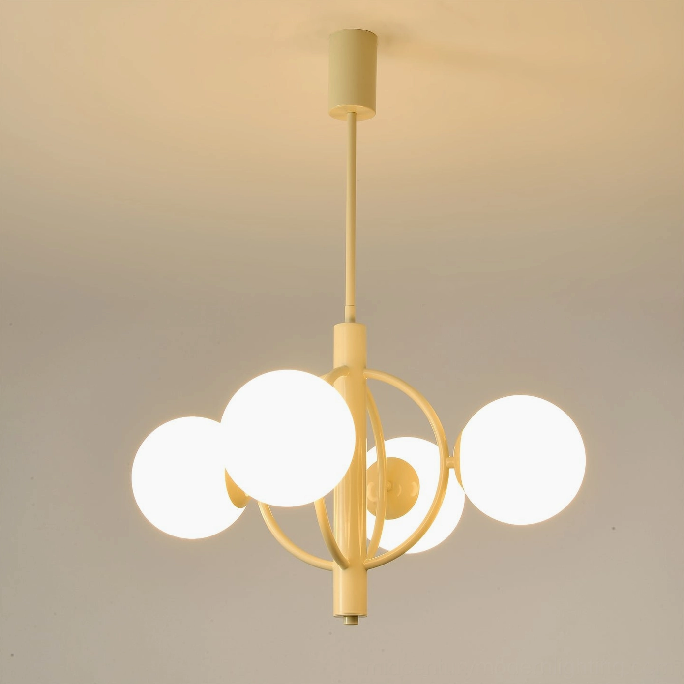 Kaiser 4-head mid-century chandelier installed, emitting warm ambient lighting