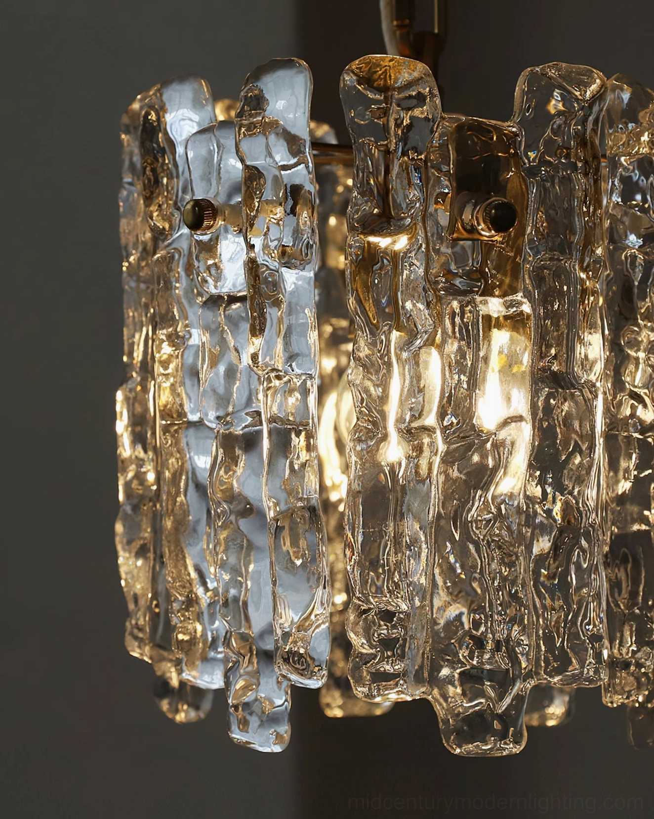 Kalmar clear textured rippled glass pendant light with illuminated interior showing minimalist luxury design aesthetic
