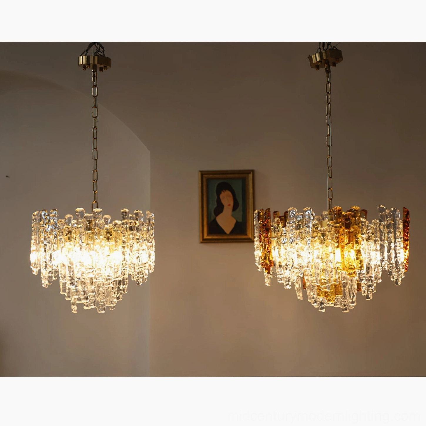 Pair of matching Kalmar mid-century modern pendant lights illuminating cozy vintage living room with warm amber glow